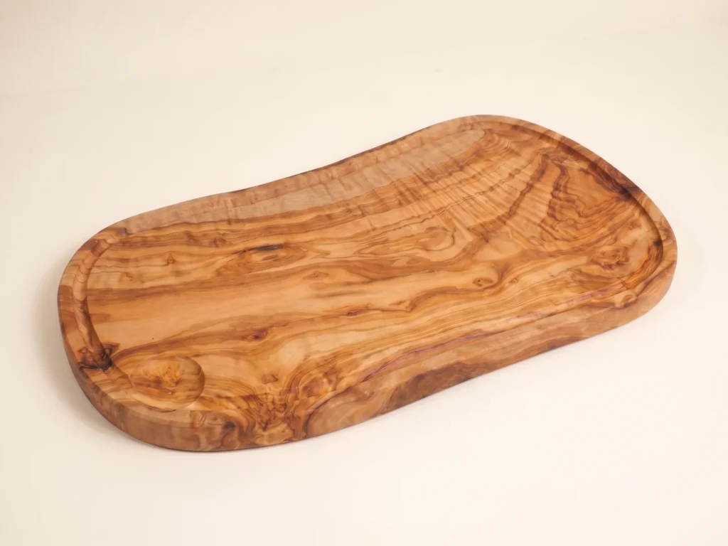 Olive wood board in a three-quarter ecommerce view on an ivory background