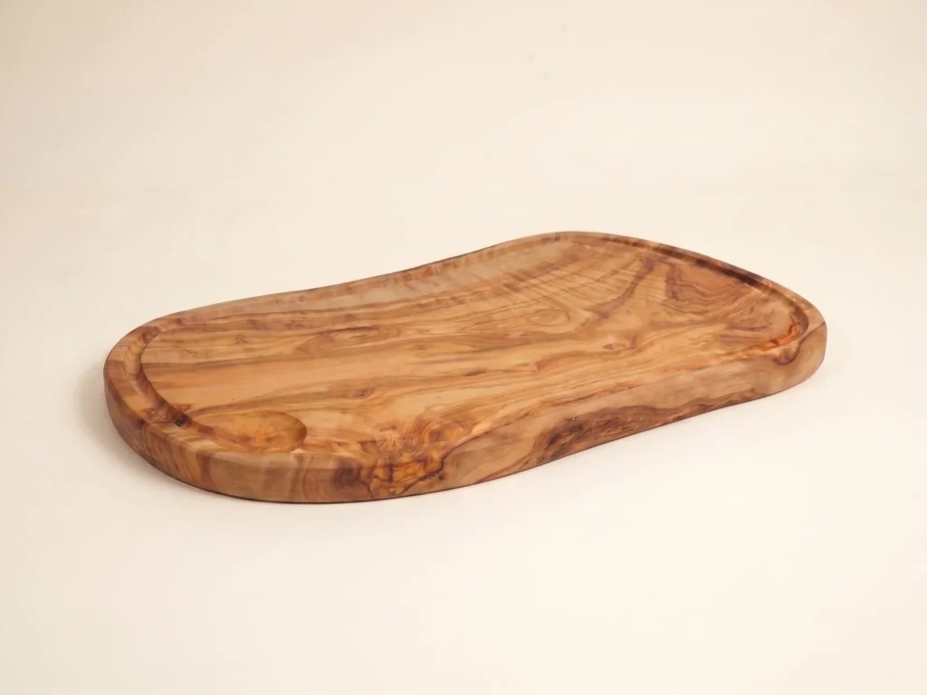 Olive wood board in a low-profile ecommerce view showing its edge