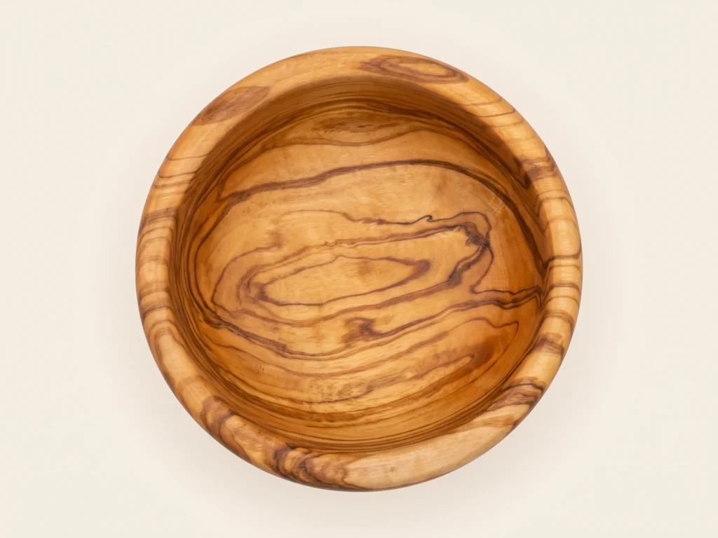 Top-down overhead view of round smooth olive wood bowl TR-1 showing circular rim and natural grain