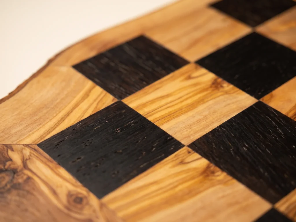 Macro close-up view of 45-degree miter corner joint and 40 mm black and olive wood inlaid squares