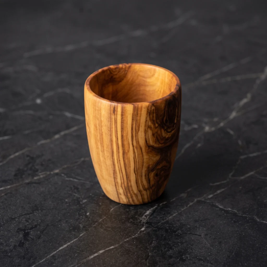 Handcrafted small olive wood cup or cordial goblet on white marble base