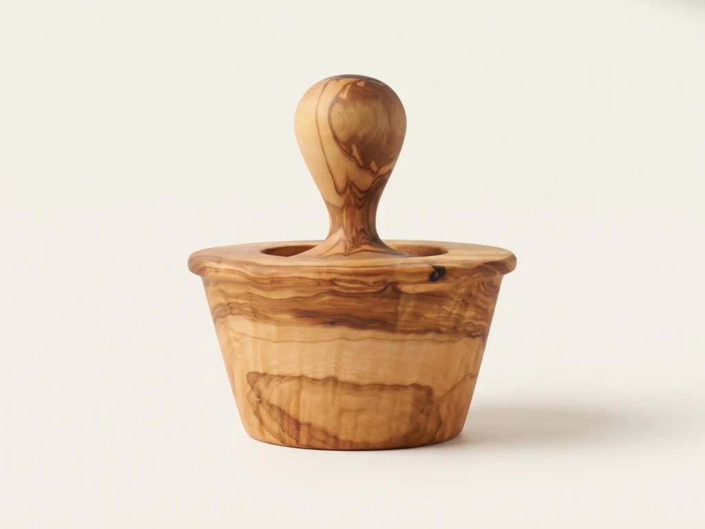 Side elevation view of conical olive wood garlic mortar showing flared profile and wide collar rim