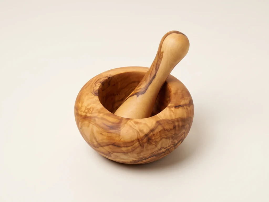 Three-quarter view of smooth round olive wood mortar and pestle TR-6 on seamless warm ivory background
