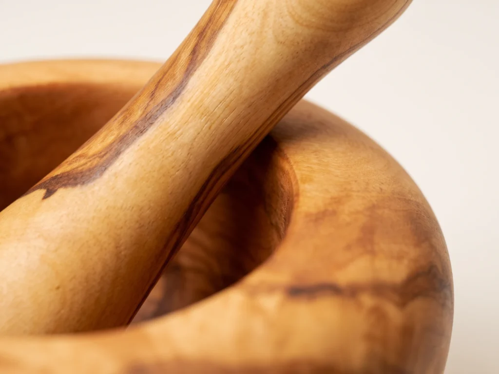 Macro close-up of smooth rounded rim and dense olive wood grain on mortar TR-6