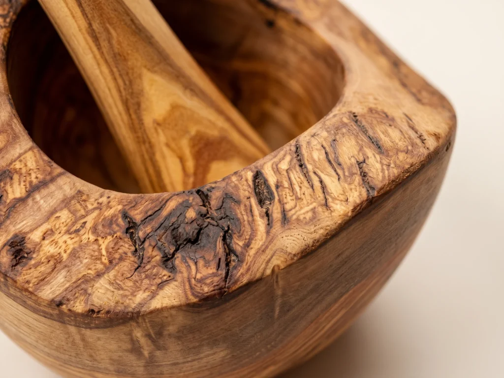 Macro close-up of natural live bark rim and dense grain on rustic olive wood mortar TR-7