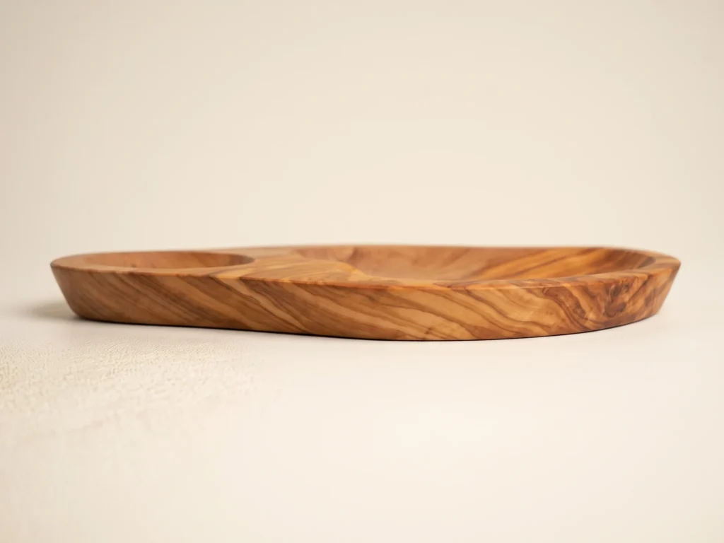Horizontal side profile of olive wood dish BL-15 displaying smooth carved rim and stable flat base