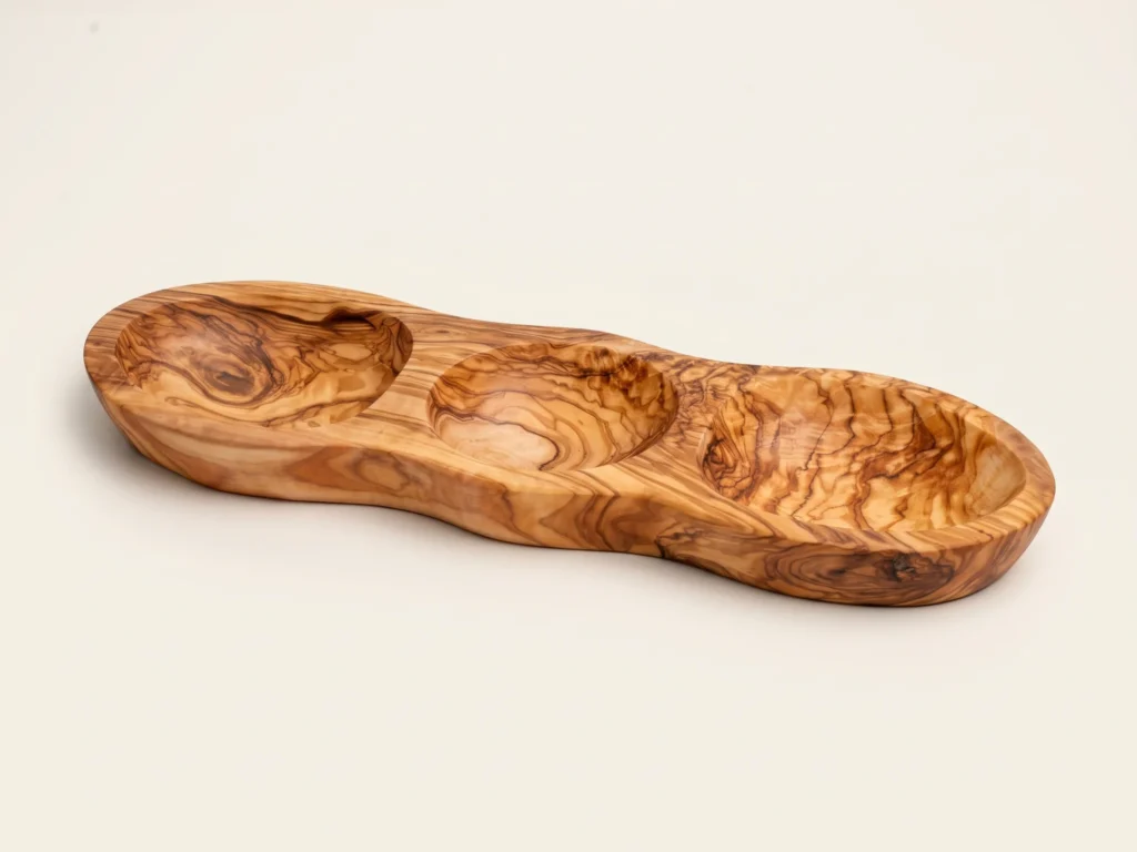 Three-quarter studio perspective of 3-section olive wood appetizer platter BL-24 on warm ivory background