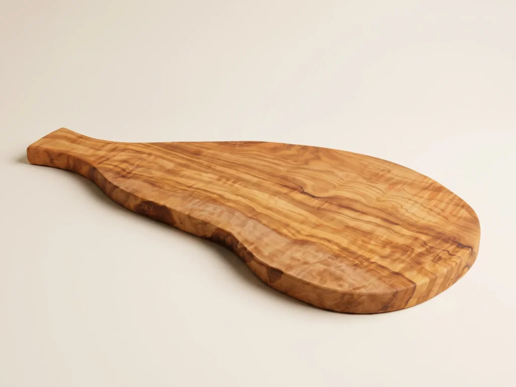 Natural shaped olive wood cutting board with handle low-profile grazing edge view