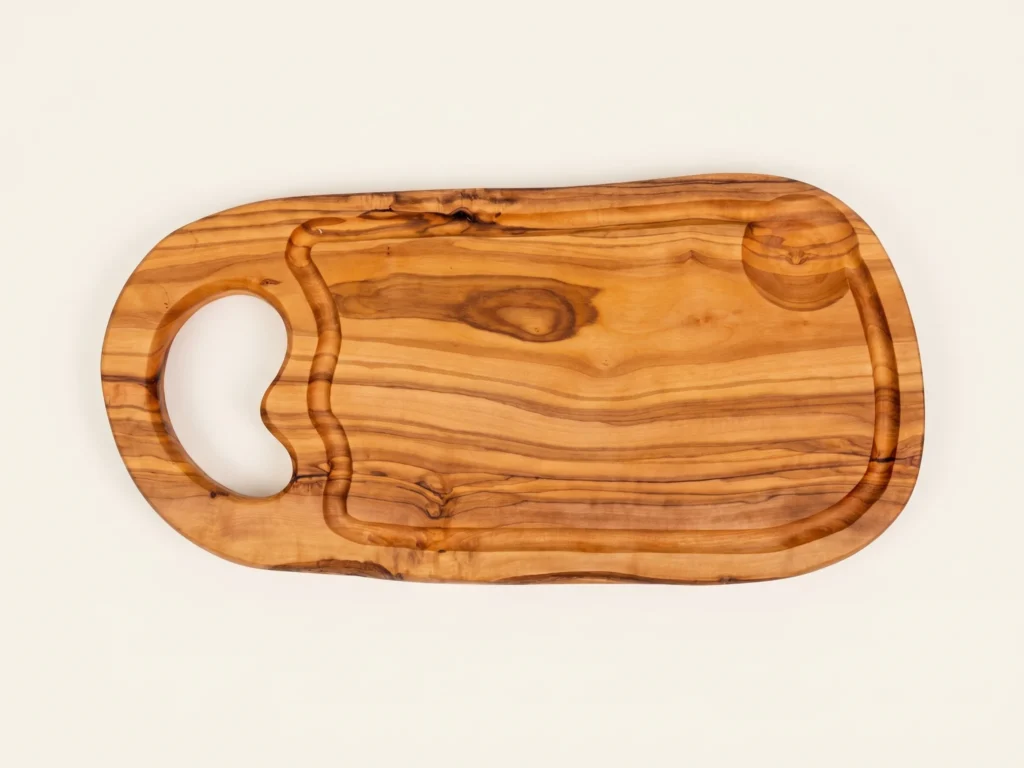 Natural shaped olive wood cutting board with juice groove and hole overhead 90-degree technical view