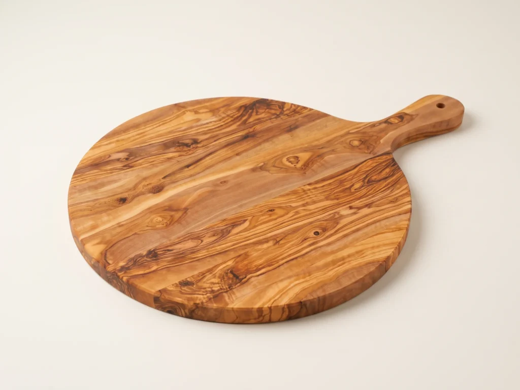 Round olive wood board with handle three-quarter perspective view