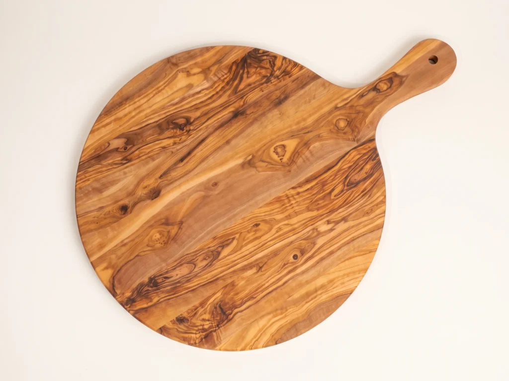 Round olive wood board with handle overhead 90 degree technical view