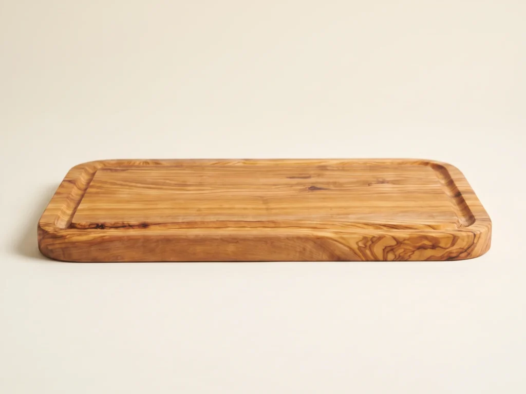 Rectangular edge-glued olive wood cutting board with rounded corners low-profile grazing edge view