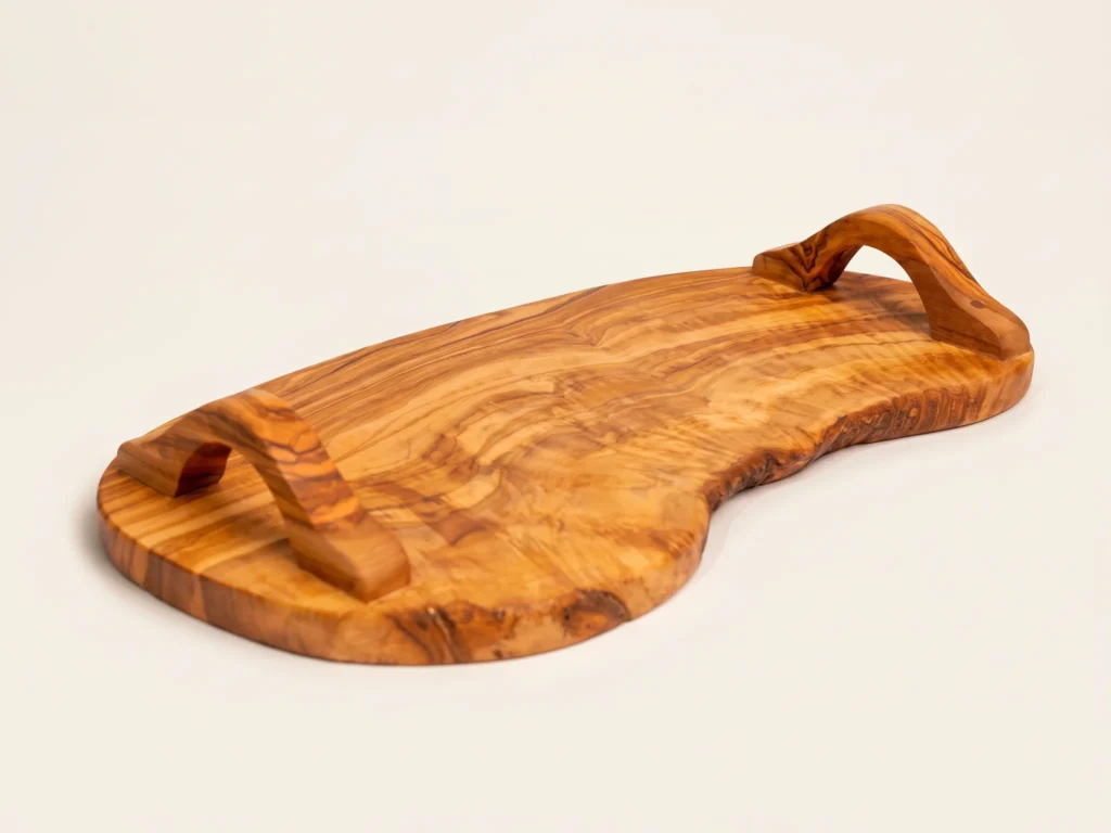 Three-quarter view of natural live-edge olive wood serving tray SC-87 showing raised arched handles and wood thickness