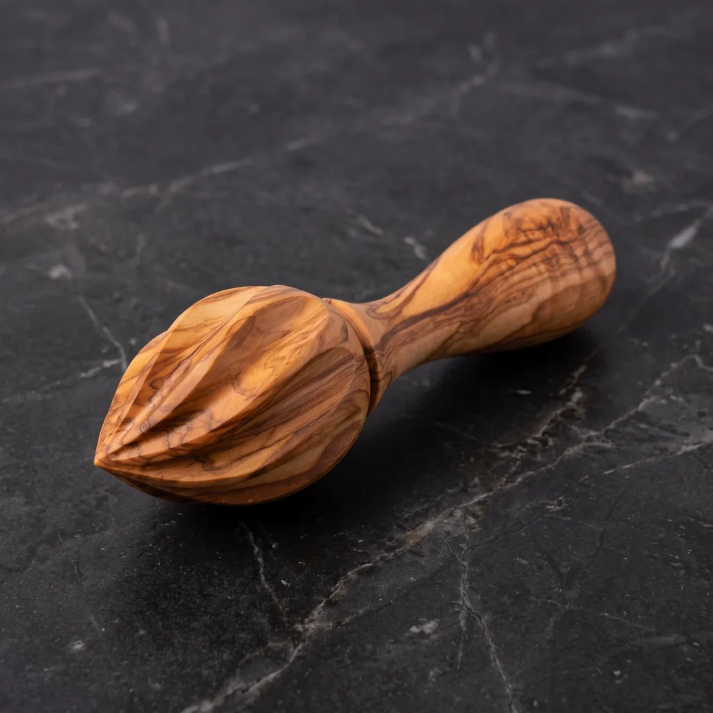 Handcrafted olive wood lemon juicer citrus reamer on black marble slab
