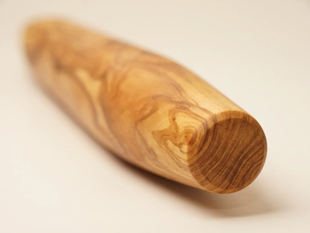 Macro close-up on the tapered circular end and olive wood growth rings TR-30