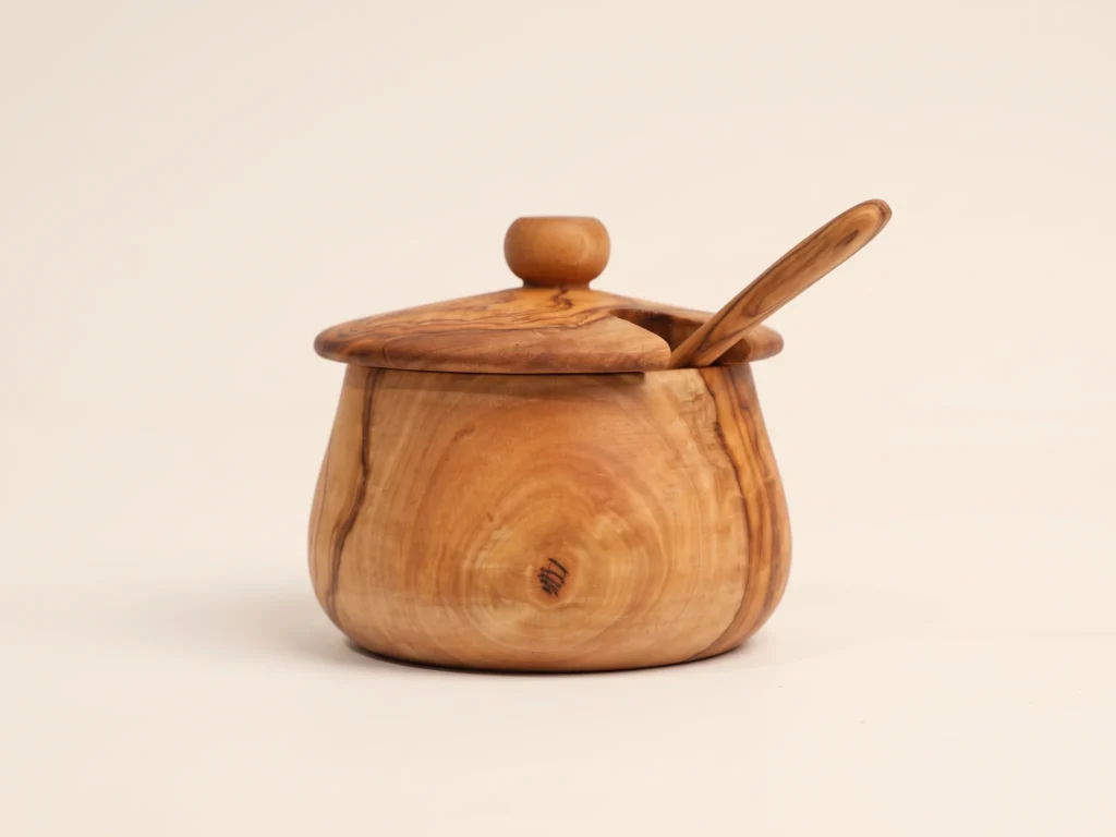 Low profile view of the olive wood sugar canister showing the flat base and the lid seating line