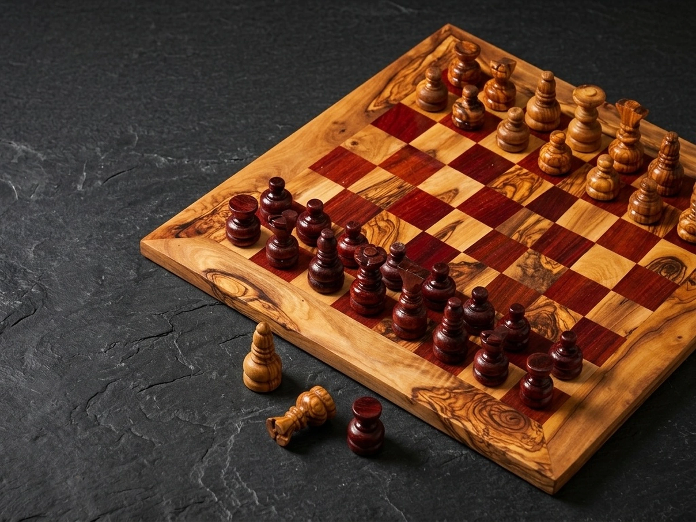 Luxury handcrafted olive wood chess set on dark slate